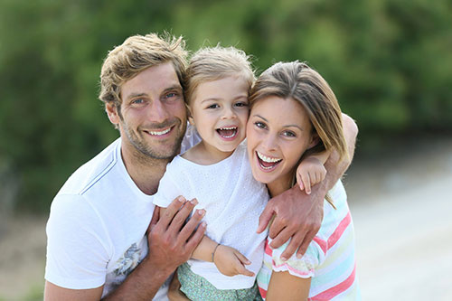 Man and woman carrying a toddler girl